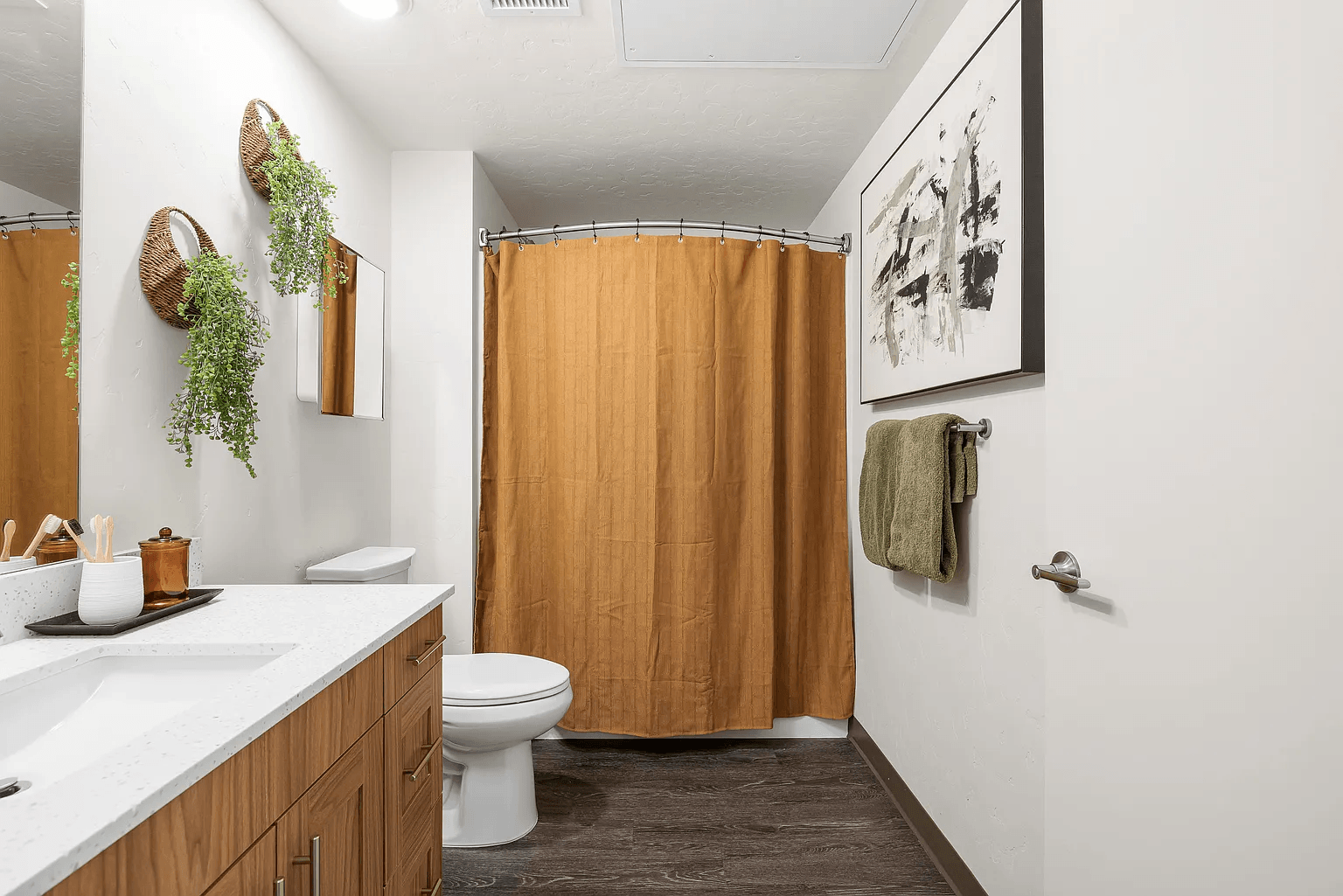 A bathroom with a toilet, sink, and shower.